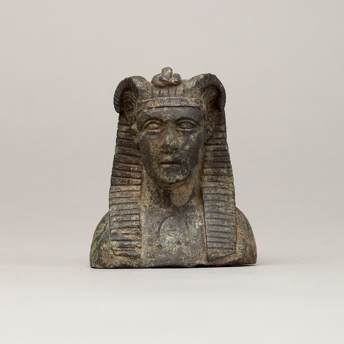 Small copper-alloy royal bust with Egyptian headdress and ram horns