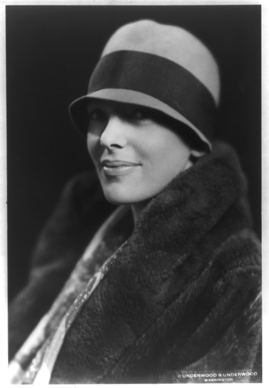 Amelia Earhart wearing a hat and fur coat