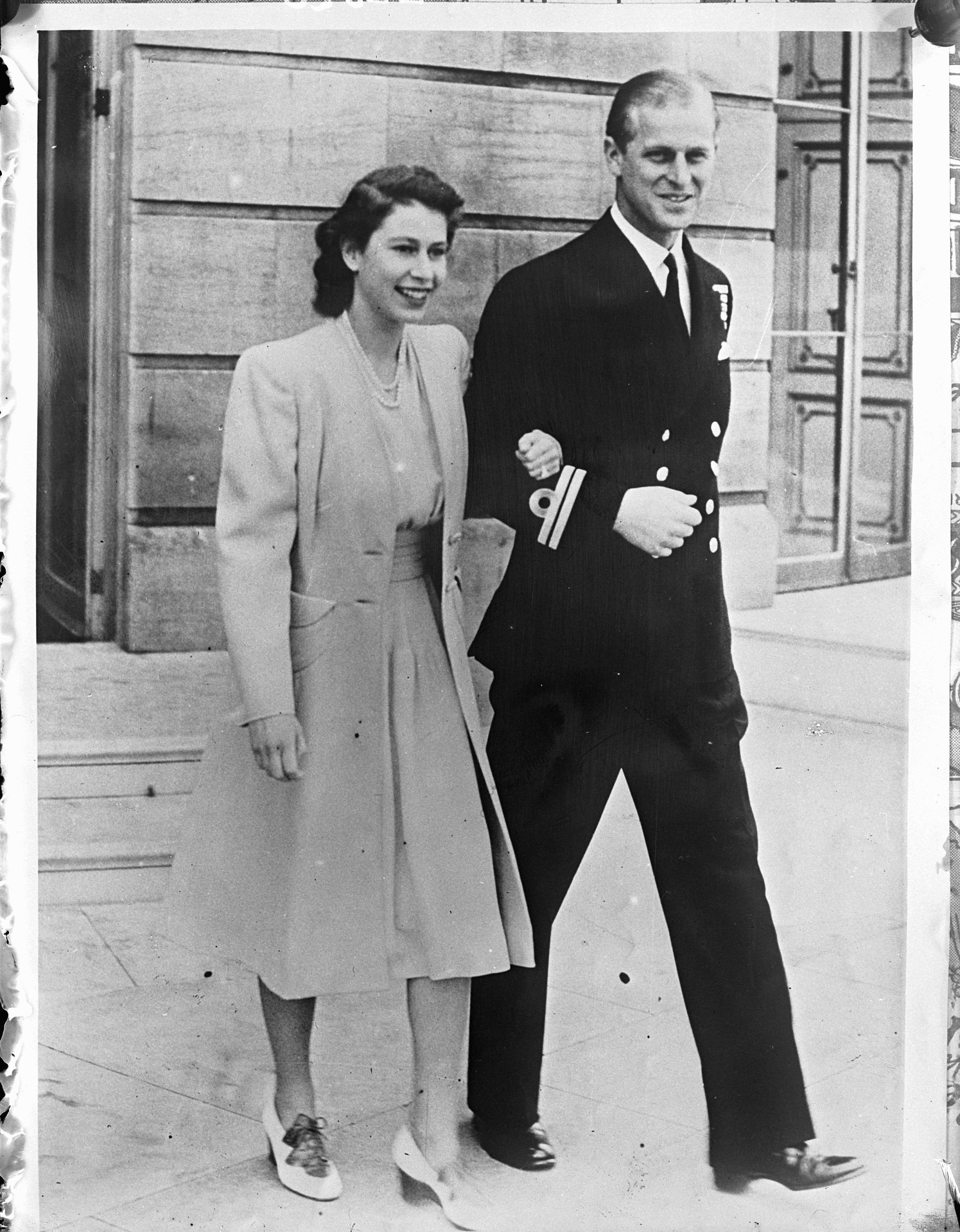 Princess Elizabeth and Philip Mountbatten standing arm in arm in July 1947.