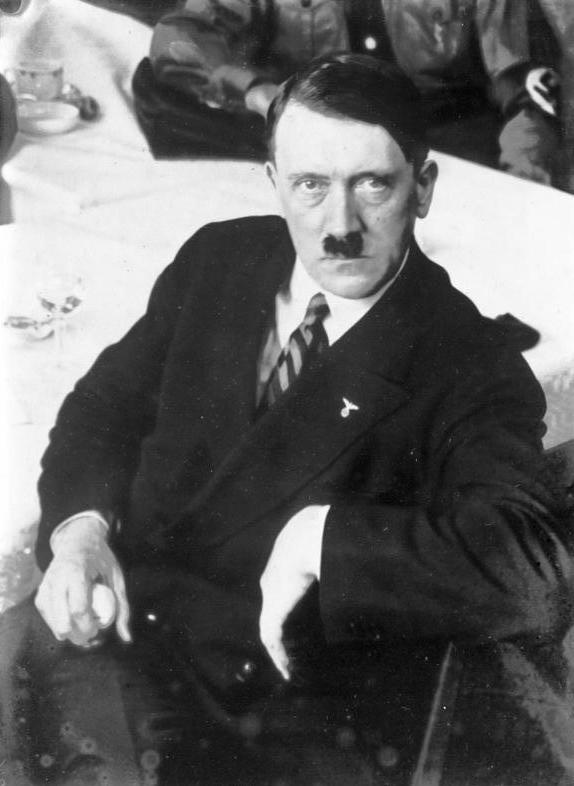 Adolf Hitler seated in a dark suit in Berlin in 1932.