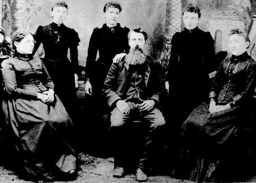 Caroline, Carrie, Laura, Charles, Grace, and Mary Ingalls in a family portrait.