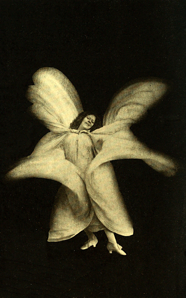 Loie Fuller dancing with flowing fabric spreading like wings around her body