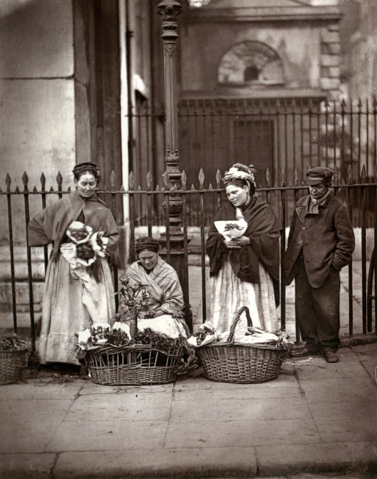 London’s poor earning a living: flower sellers with baskets outside St Paul’s Church in Covent Garden, 1877