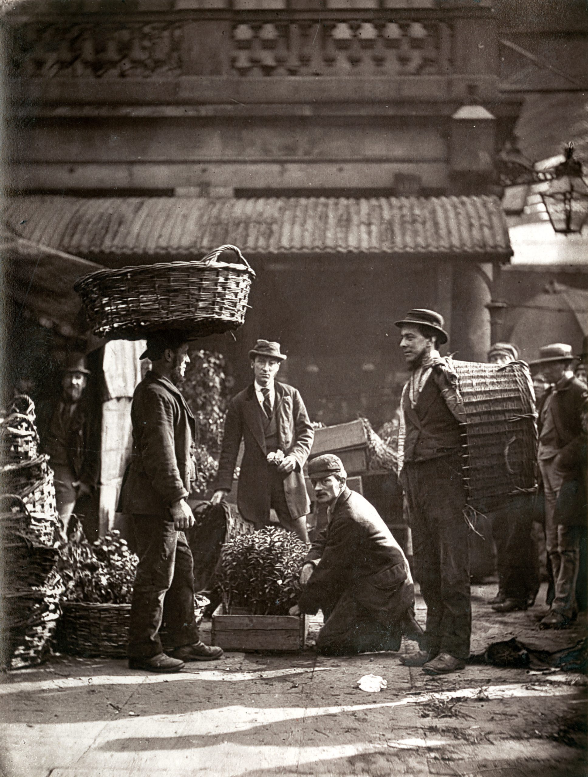 London market laborers carrying baskets in the Covent Garden flower trade, photographed in 1877