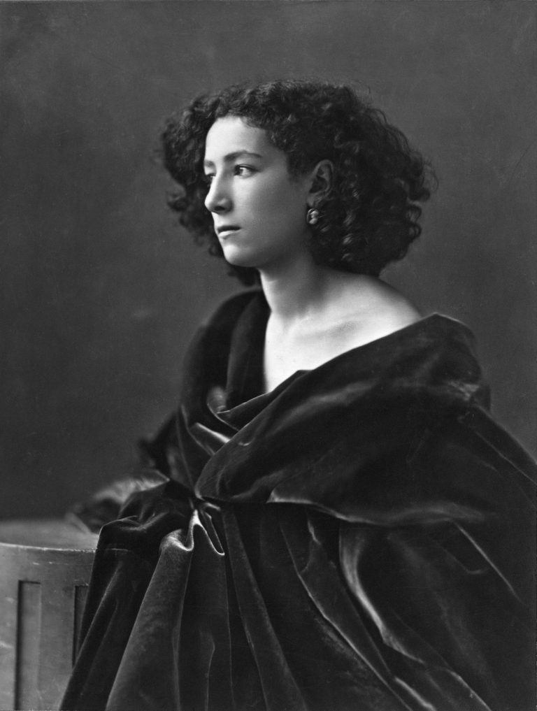 Sarah Bernhardt wrapped in a dark drape in an 1864 portrait by Nadar