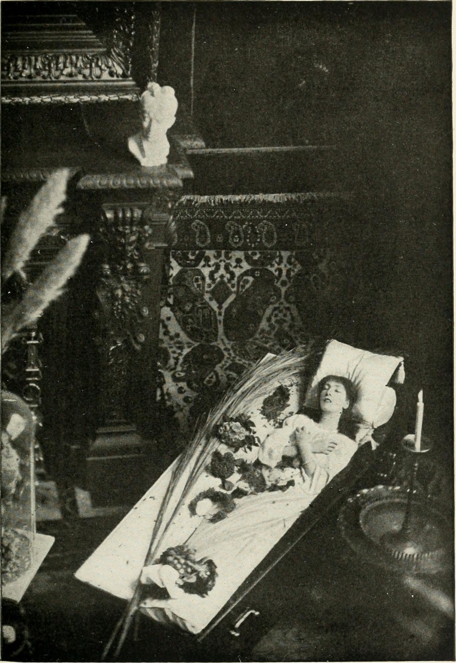 Sarah Bernhardt posing in a coffin in a photograph reproduced in her memoir
