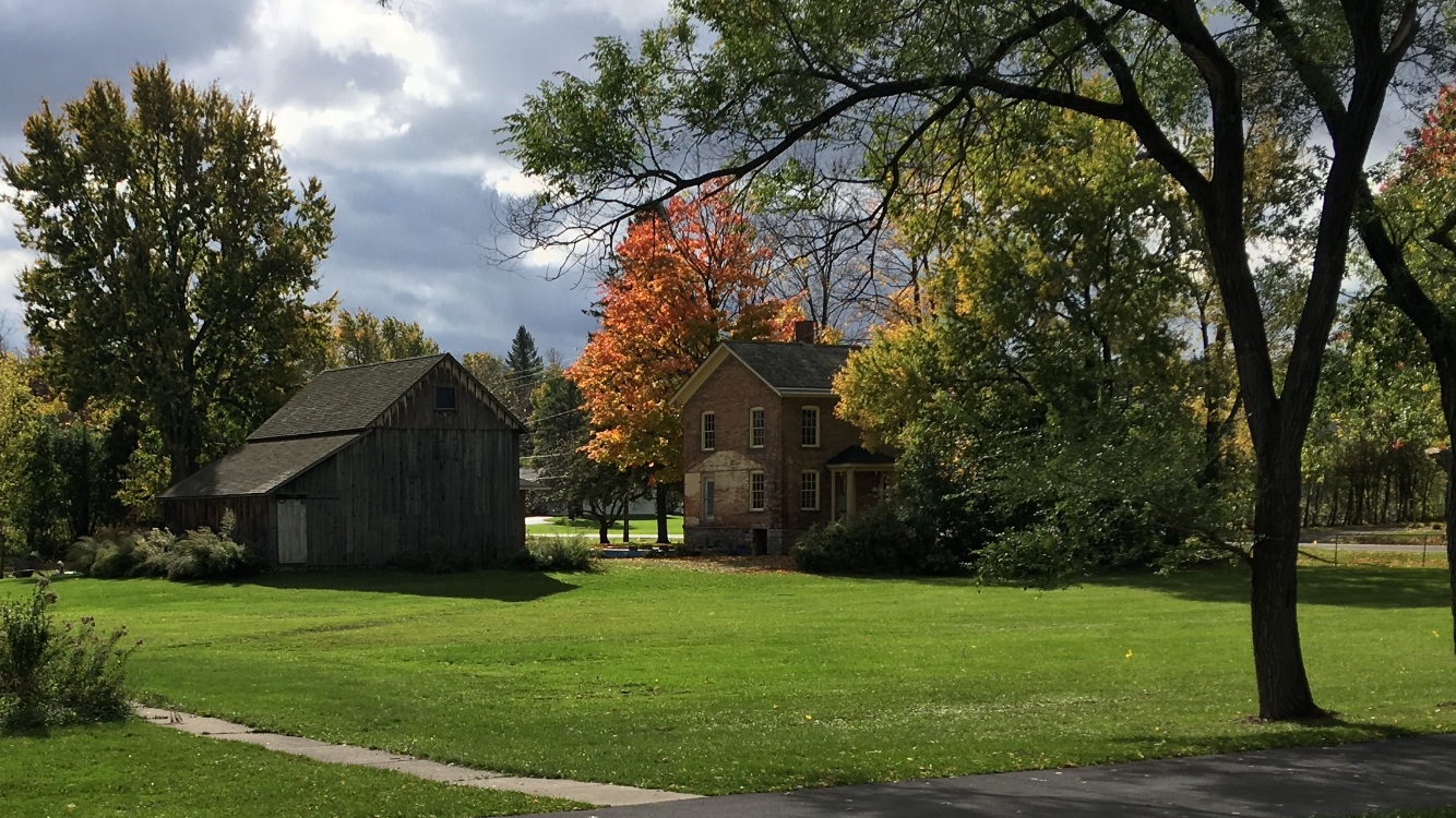 Brick home and wooden barn at Harriet Tubman’s Auburn property